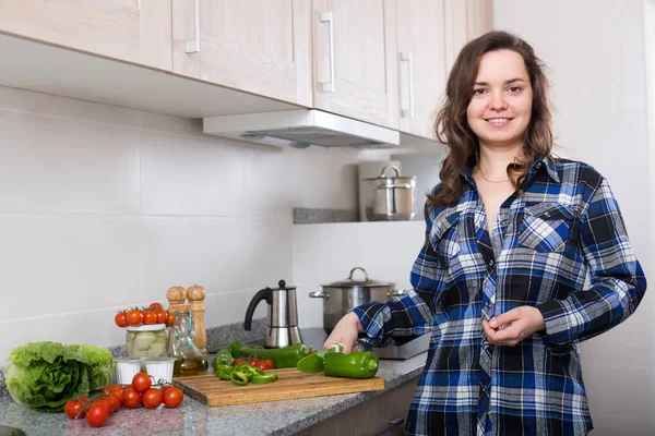 Glückliche Frau bereitet Gemüse bei hom zu — Stockfoto