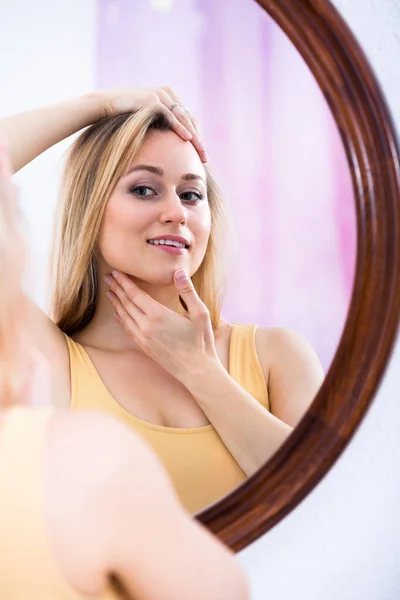 Giovane donna che guarda nel mirro — Foto Stock