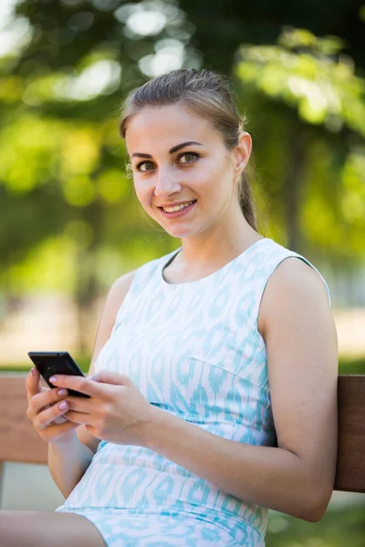 Gelukkig Oekraïens Meisje Zitten Een Bank Met Behulp Van Telefoon — Stockfoto