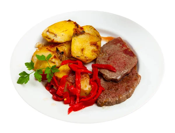 Appetizing beef entrecote with french fries and stewed bell peppers at plate — Stock Photo, Image