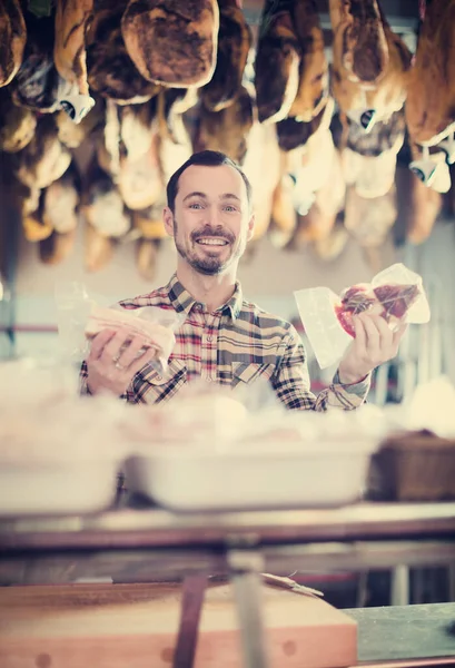 Seller offering sorts of meat — Stock Photo, Image