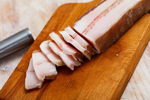 Tasty salted pork belly on wooden surface — Stock Photo, Image