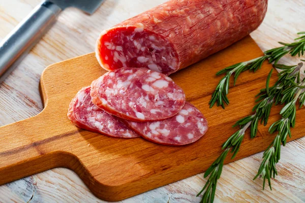 Appetizing salchichon sausage on wooden table — Stock Photo, Image