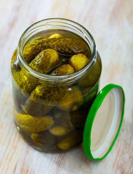 Pickled cucumbers with spices in glass jar — Stock Photo, Image