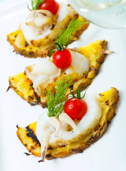 Sepia fried on a grill with pineapple and cherry tomatoes is tasty dish — Stock Photo, Image