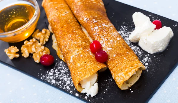 Bulgarian crepes Palatschinke on black board — Stock Photo, Image