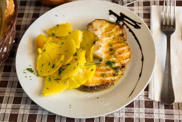 Slices of poor cod with green sauce — Stock Photo, Image