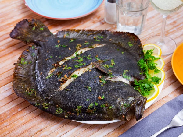 Close view of baked flounder on plate with parsley — Stock Photo, Image