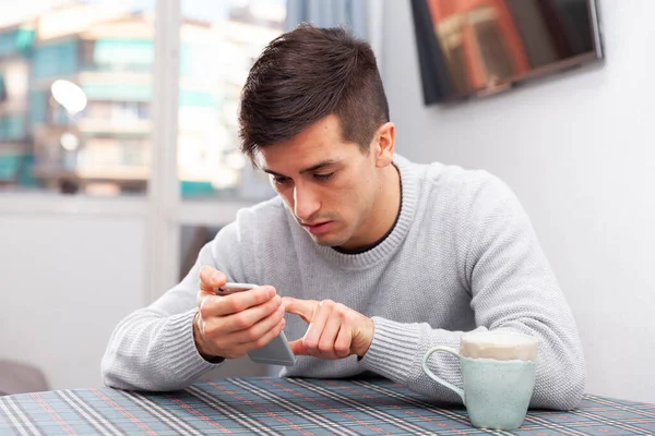 Young man is sad sitting with phone because she is alone — Stock Photo, Image