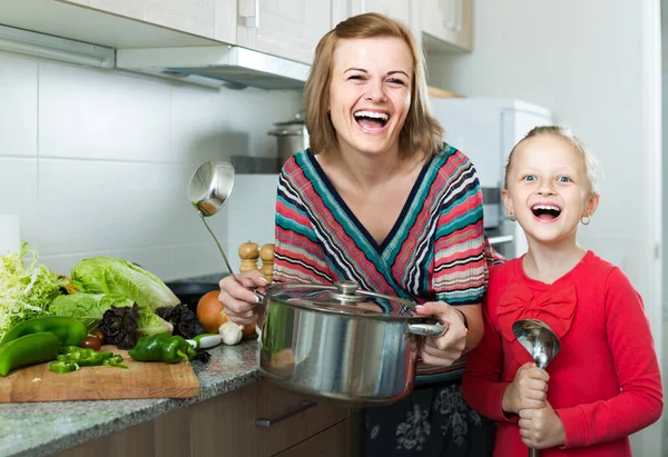 Anne ve küçük kızı birlikte çorba tadıyorlar. — Stok fotoğraf