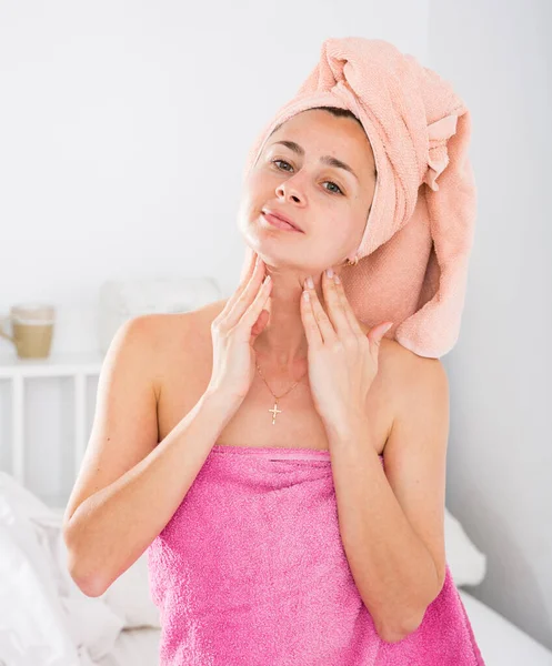 Portrait of cute adult woman with towel on head posing in bedroom — Stock Photo, Image