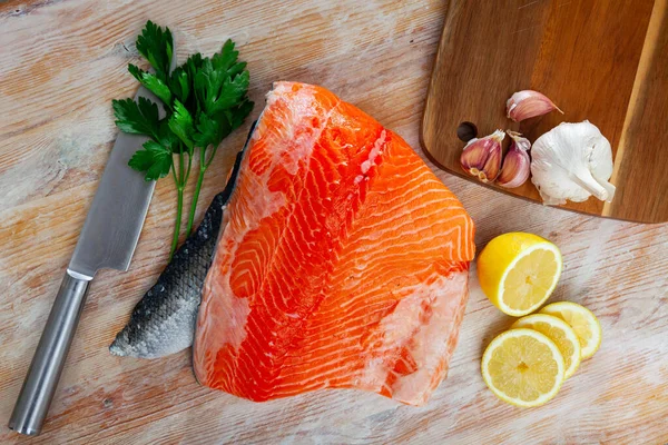 Appetitlich rohes Lachsfilet mit Zitrone und Gemüse — Stockfoto