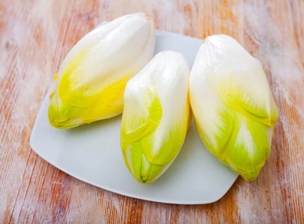 Image of fresh raw endive on the wooden table — Stock Photo, Image