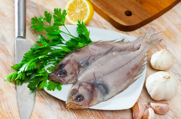 Raw fresh rooster fish before cooking on wooden desk — Stock Photo, Image