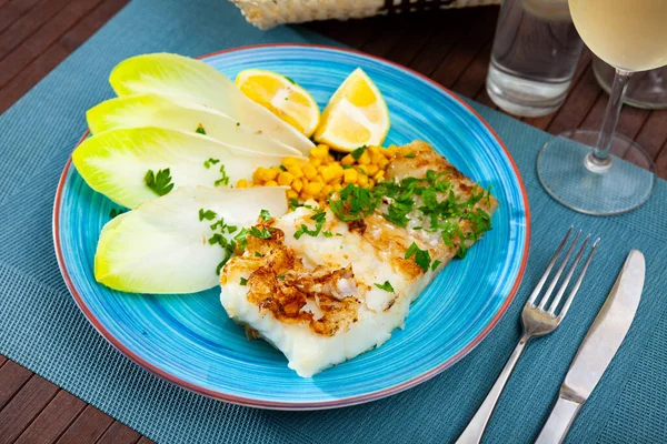 Delicious fried cod fillet with endive, corn, and greens — Stock Photo, Image