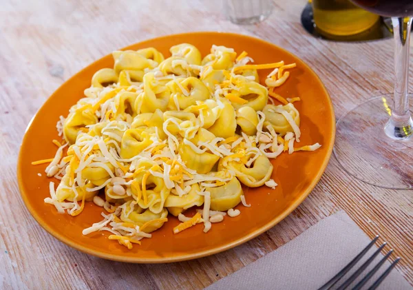 Tortellini with two varieties of grated cheese and pine nuts — Stock Photo, Image