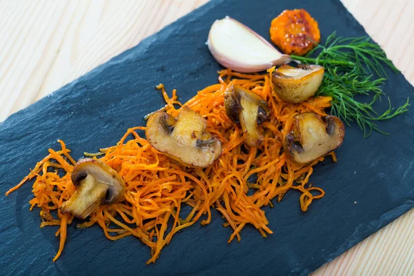 Roasted champignons with julienne carrots — Stock Image Roasted champignons with julienne carrots Stock Picture
