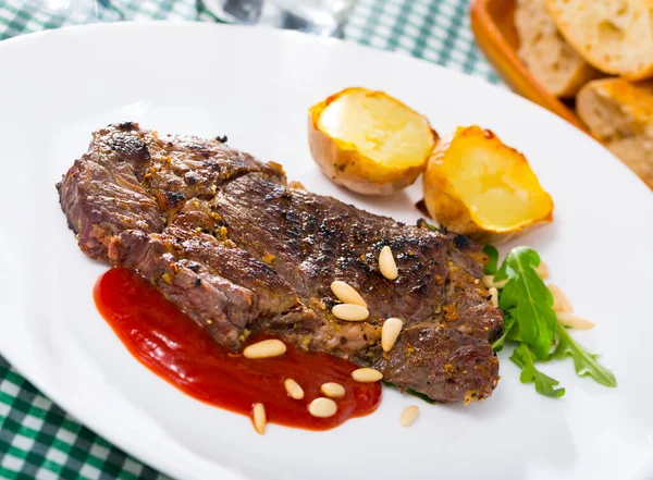 Well done roasted veal steak with ketchup, pine nuts — Stock Photo, Image