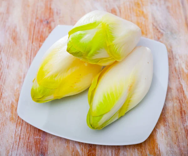 Image of fresh raw endive on the wooden table — Stock Photo, Image