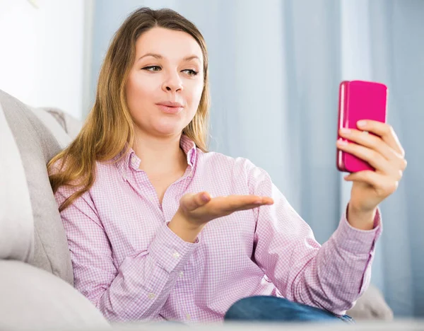 Positieve vrouw met behulp van haar telefoon en het nemen van foto 's — Stockfoto