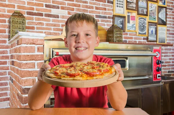 Joyful Teenager Pizza His Hand Wooden Board Cafe — Stock Photo, Image