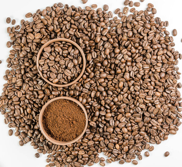 coffee beans and ground coffee on the scattered beans