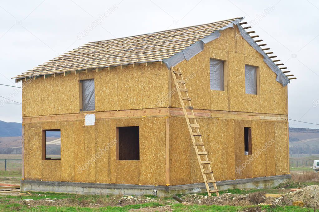 Construction of a wooden house of SIP panels. Element of building design.