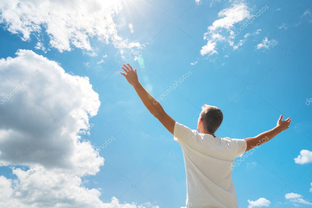 Man strive hands to the deep blue sky and sun. Religion and conceptual scene. Worship to God. 