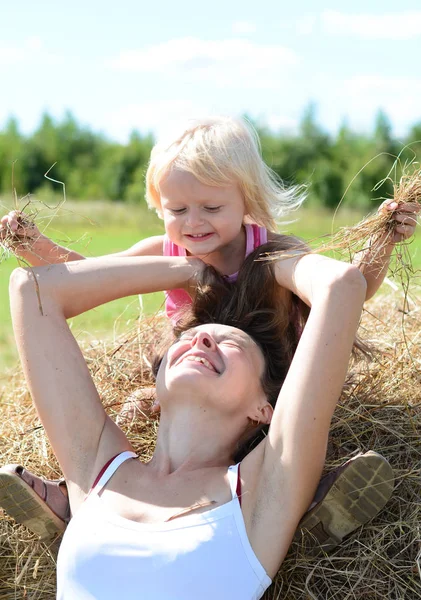 Portrait of  mother and child near haystack — Stock Photo, Image