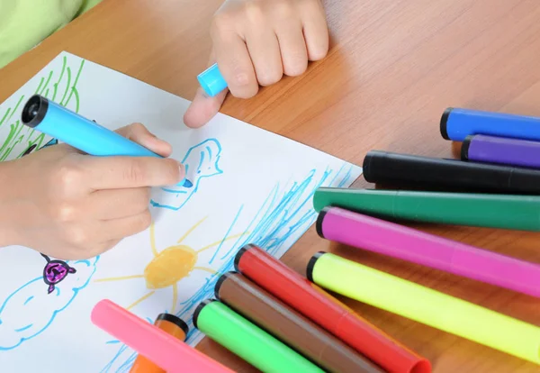 Unrecognizable child drawing picture on paper pencil — Stock Photo, Image