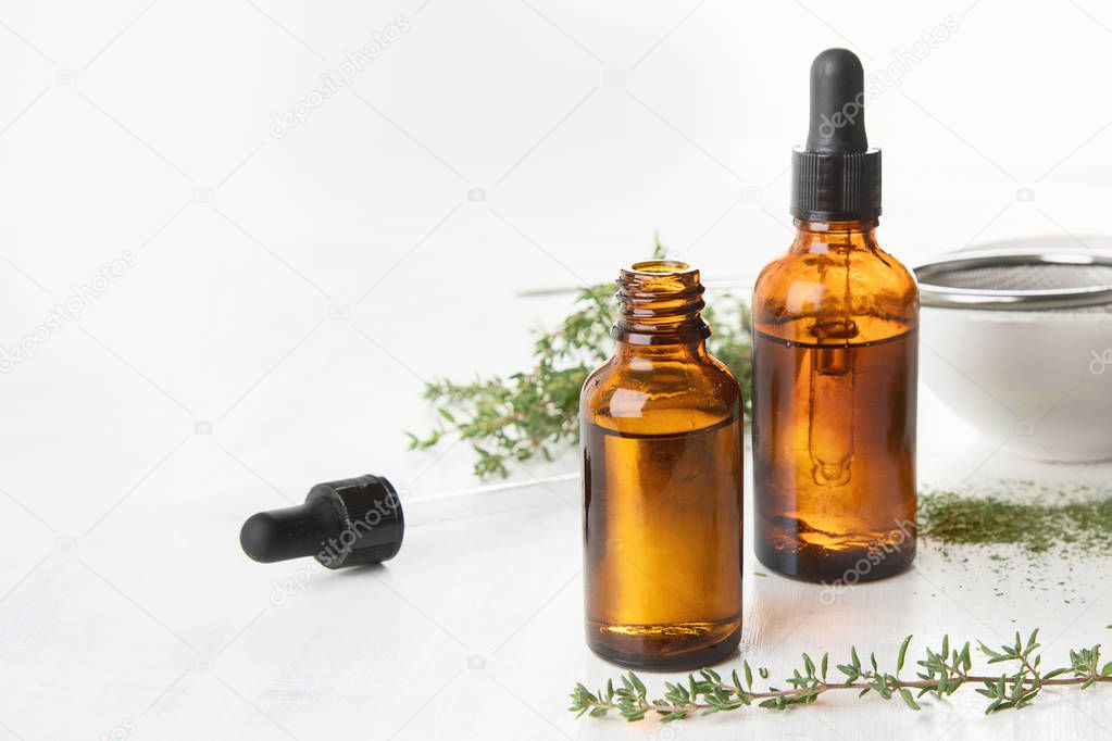 Thyme essential oil with fresh thyme twigs