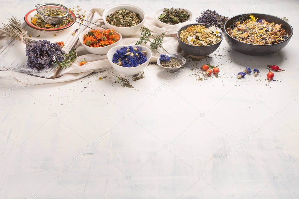 Dried herbal tea ingredients on white background