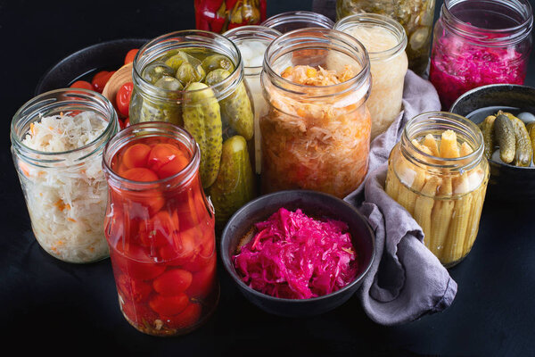 Fermented preserved food. Marinated pickles vegetables in glass jars.