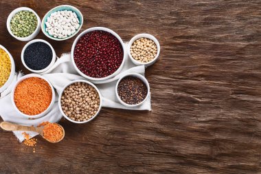 Kase ahşap tahta üzerinde çeşitli kuru baklagiller.