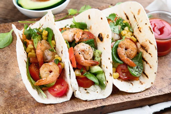 Mexican tacos with shrimps and avocado.