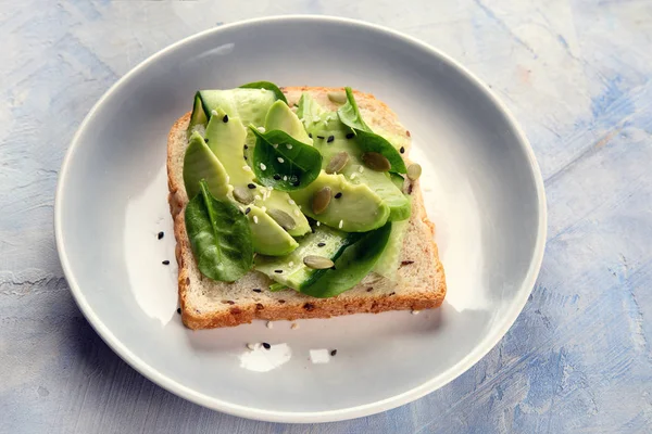 Avocado sandwich on plate.  Vegan and vegetarian food