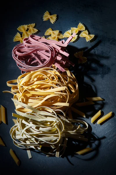 Italian Raw Uncooked Tagliatelle Pasta Black Background — Stock Photo, Image