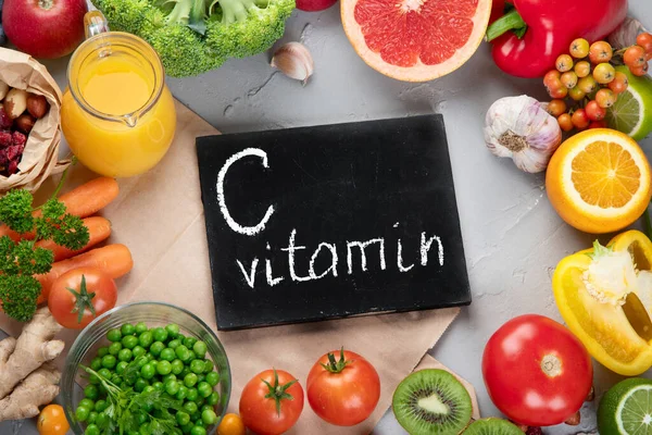 Foods high in vitamin C. Food rich in antioxidant, fiber, carbohydrates. Boost immune system and brain; balances cholesterol; promotes healthy heart. Top view, copy space , with chalkboard