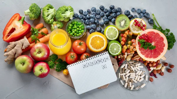 Foods high in vitamin C. Food rich in antioxidant, fiber, carbohydrates. Boost immune system and brain; balances cholesterol; promotes healthy heart. Top view, copy space , with chalkboard , with empty notebook