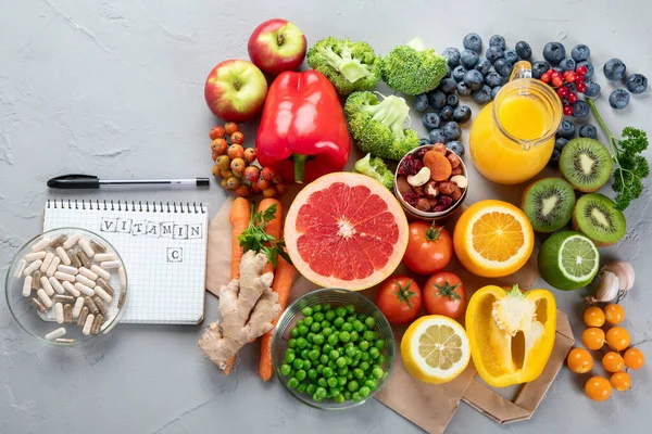 Foods high in vitamin C. Food rich in antioxidant, fiber, carbohydrates. Boost immune system and brain; balances cholesterol; promotes healthy heart. Top view, copy space , with chalkboard , with empty notebook