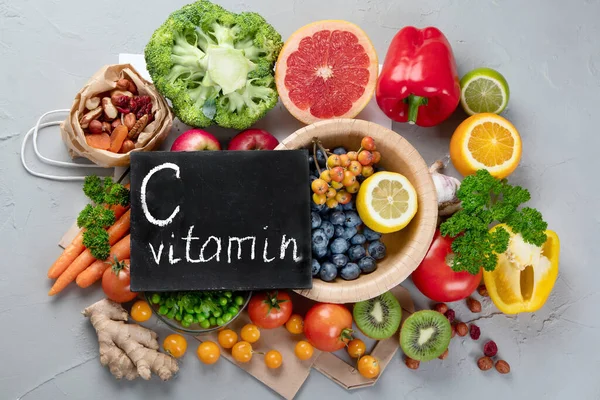 Foods high in vitamin C. Food rich in antioxidant, fiber, carbohydrates. Boost immune system and brain; balances cholesterol; promotes healthy heart. Top view, copy space , with chalkboard