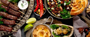 Orta Doğu ya da Arap mutfağı. Arka planda çeşitli yemekler var. Üst görünüm.