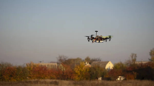 Flying drone above rural buildings
