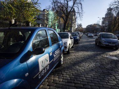 KIEV, UKRAINE - November 7, 2018: Car with Uber logo parcked in goverment district of Ukranian Capital clipart