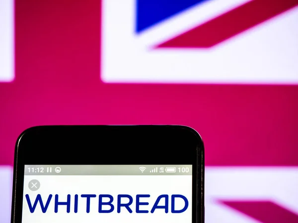 Whitbread logotipo da empresa plc visto exibido no telefone inteligente . — Fotografia de Stock