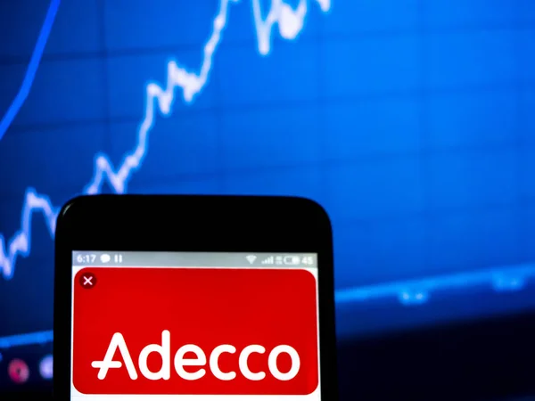 Photo illustration The Adecco Group logo seen displayed on a sma — Stock Photo, Image