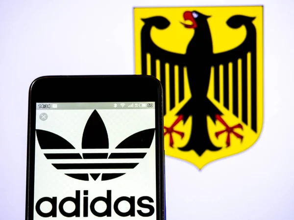 У цій ілюстрації фото Adidas AG логотип видно відображається на — стокове фото