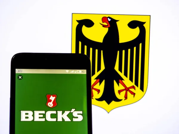 In this photo illustration a Beck���s logo seen displayed on a s — стокове фото