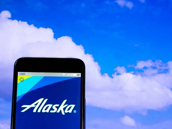 In this photo illustration the Alaska Airlines logo is seen disp