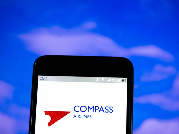 In dieser Foto-Illustration wird das Kompass-Airlines-Logo auf einem Smartphone angezeigt — Stockbild In dieser Foto-Illustration ist das Kompass-Airlines-Logo zu sehen. — Stockfoto